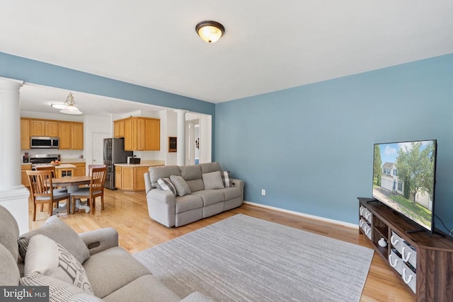 12314 Osprey Ln, Culpeper, VA 22701 - living room featuring ornate columns and light wood-style floors