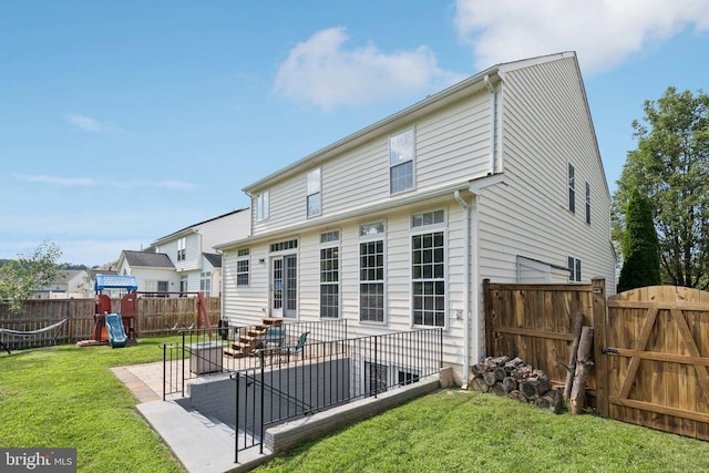 12314 Osprey Ln, Culpeper, VA 22701 - back of property featuring a fenced backyard, a playground, a gate, and a patio