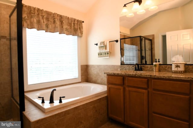 full bath featuring vaulted ceiling, vanity, a shower stall, and a bath