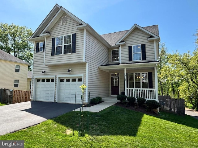view of front of property featuring a porch, a front lawn, fence, and driveway