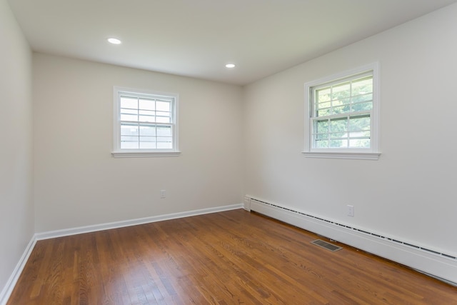 1002 Coalter St, Staunton, VA 24401 - empty room with a baseboard radiator, wood finished floors, baseboards, and recessed lighting