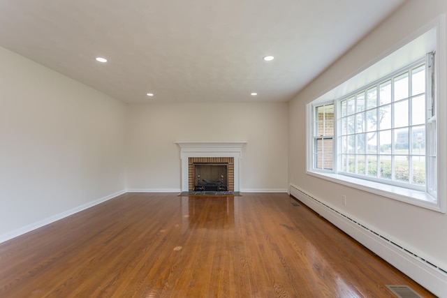 1002 Coalter St, Staunton, VA 24401 - unfurnished living room with a baseboard radiator, recessed lighting, a fireplace, wood finished floors, and baseboards