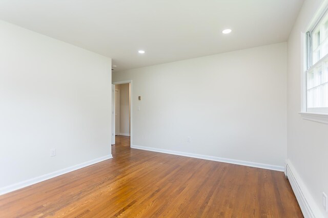 1002 Coalter St, Staunton, VA 24401 - empty room with wood finished floors, recessed lighting, baseboards, and baseboard heating