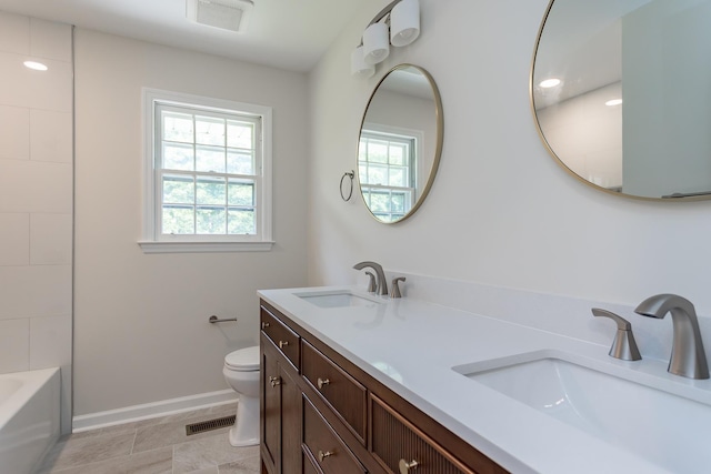1002 Coalter St, Staunton, VA 24401 - full bathroom with double vanity, healthy amount of natural light, toilet, and baseboards