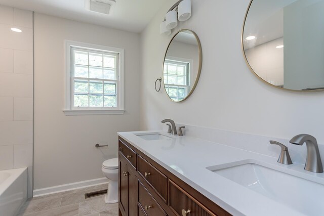 1002 Coalter St, Staunton, VA 24401 - full bathroom with double vanity, healthy amount of natural light, toilet, and baseboards