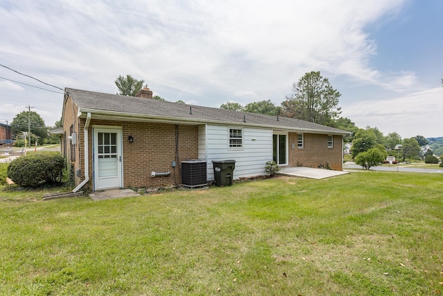 1002 Coalter St, Staunton, VA 24401 - back of property featuring a lawn, a chimney, brick siding, a patio area, and central air condition unit