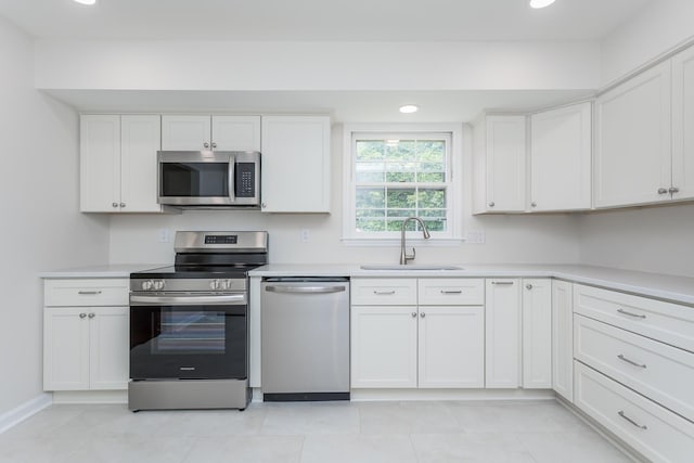 1002 Coalter St, Staunton, VA 24401 - kitchen with appliances with stainless steel finishes, a sink, white cabinets, light countertops, and recessed lighting