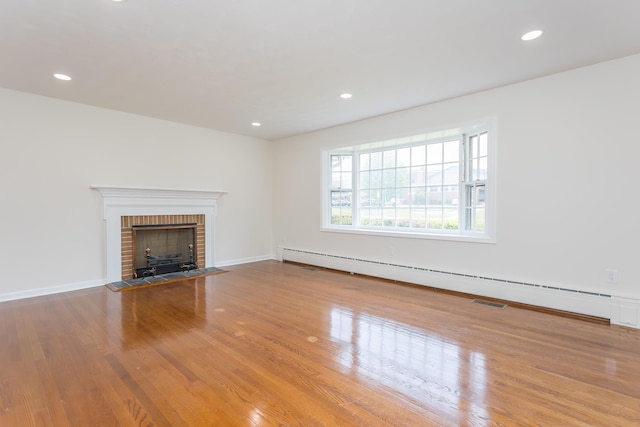 1002 Coalter St, Staunton, VA 24401 - unfurnished living room with baseboard heating, a fireplace, wood finished floors, recessed lighting, and baseboards