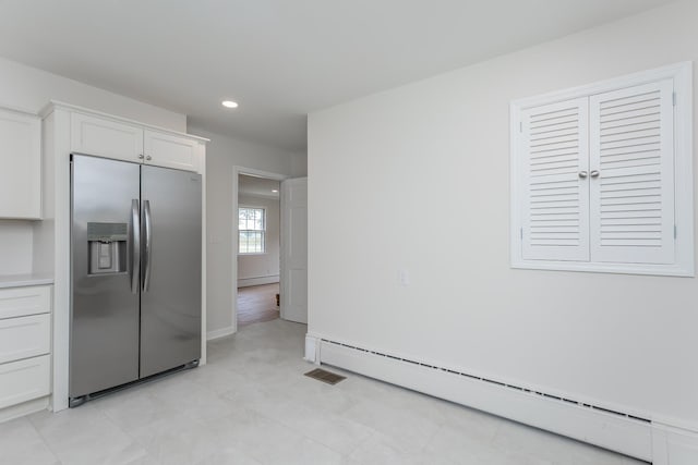 1002 Coalter St, Staunton, VA 24401 - kitchen featuring stainless steel fridge with ice dispenser, baseboard heating, white cabinets, recessed lighting, and light countertops