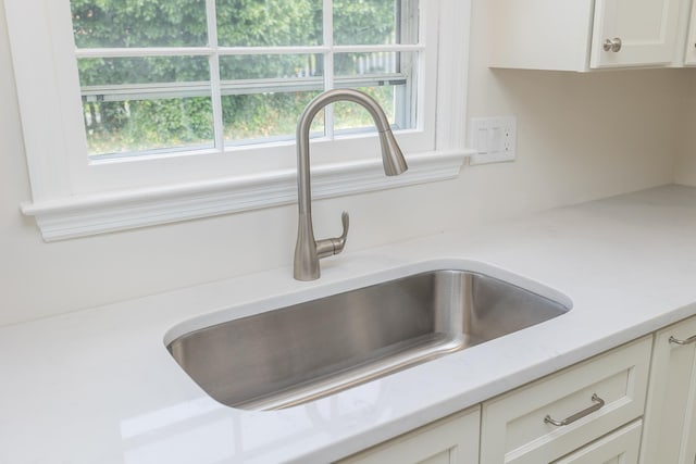 1002 Coalter St, Staunton, VA 24401 - kitchen view of a sink, light countertops, and white cabinets