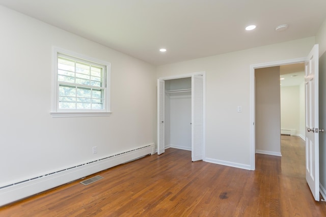 1002 Coalter St, Staunton, VA 24401 - unfurnished bedroom with baseboard heating, wood finished floors, a baseboard radiator, recessed lighting, and baseboards