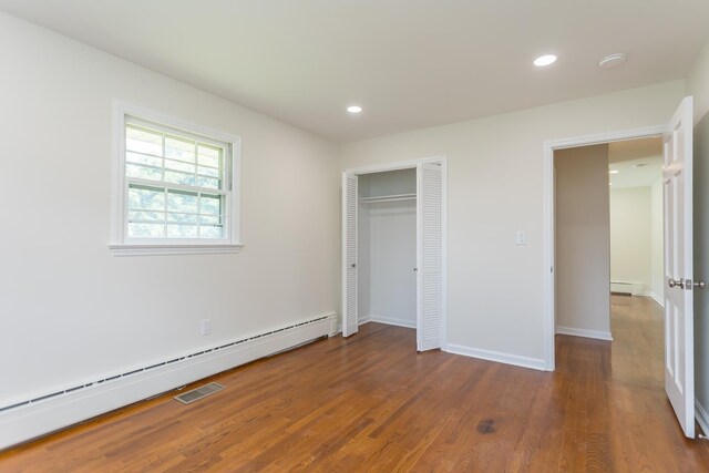 1002 Coalter St, Staunton, VA 24401 - unfurnished bedroom with baseboard heating, wood finished floors, a baseboard radiator, recessed lighting, and baseboards