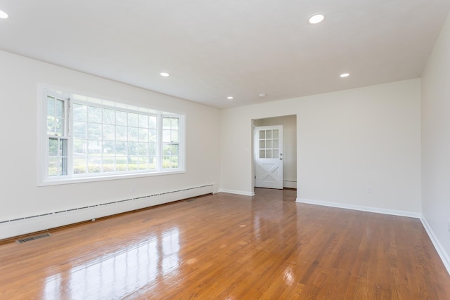 1002 Coalter St, Staunton, VA 24401 - unfurnished room featuring baseboard heating, baseboards, wood finished floors, and recessed lighting