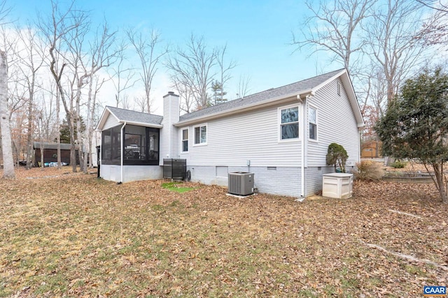 rear view of property featuring central AC, a chimney, a sunroom, and crawl space