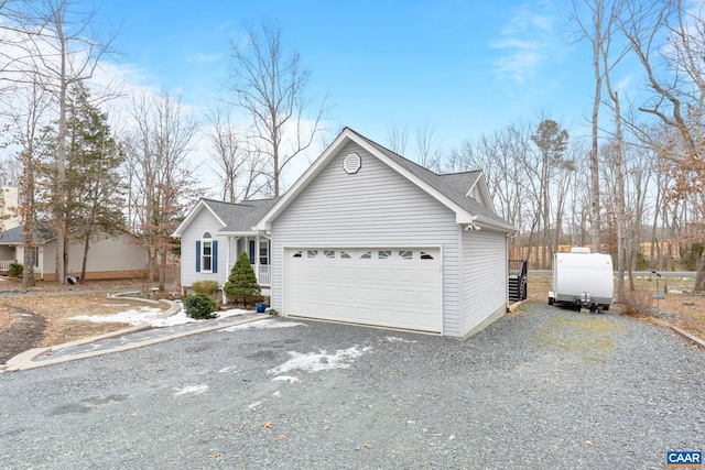 view of front of home featuring a shingled roof, driveway, and a garage