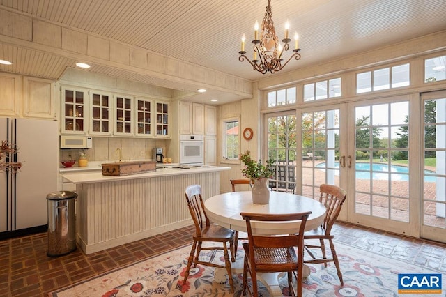 240 Broad Axe Rd, Charlottesville, VA 22903 - dining area with recessed lighting, french doors, an inviting chandelier, and brick floor
