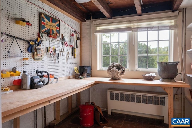 240 Broad Axe Rd, Charlottesville, VA 22903 - miscellaneous room with beamed ceiling, brick floor, a workshop area, and radiator heating unit