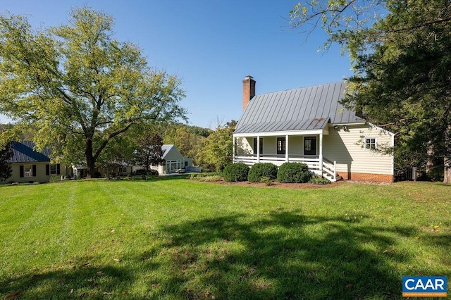 240 Broad Axe Rd, Charlottesville, VA 22903 - exterior space with covered porch, a chimney, metal roof, a front yard, and a standing seam roof