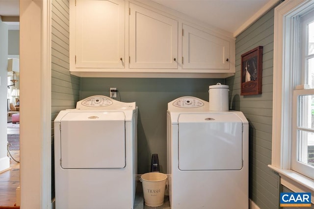 240 Broad Axe Rd, Charlottesville, VA 22903 - clothes washing area featuring wood walls, cabinet space, plenty of natural light, and washer and dryer