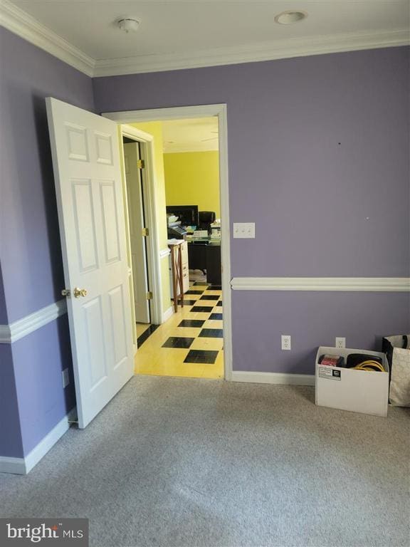 spare room featuring baseboards, ornamental molding, an office area, light colored carpet, and a smoke detector