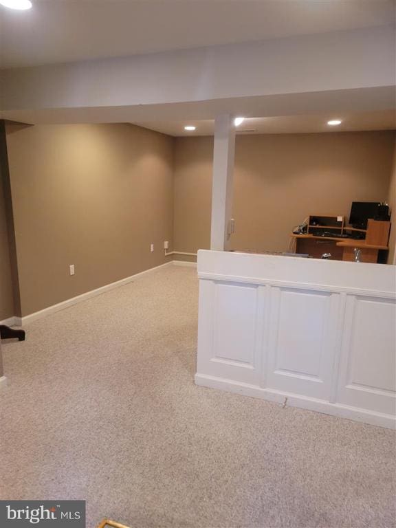 finished below grade area with carpet flooring, recessed lighting, and baseboards