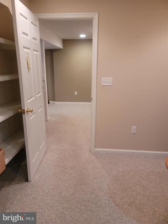 corridor featuring carpet and baseboards