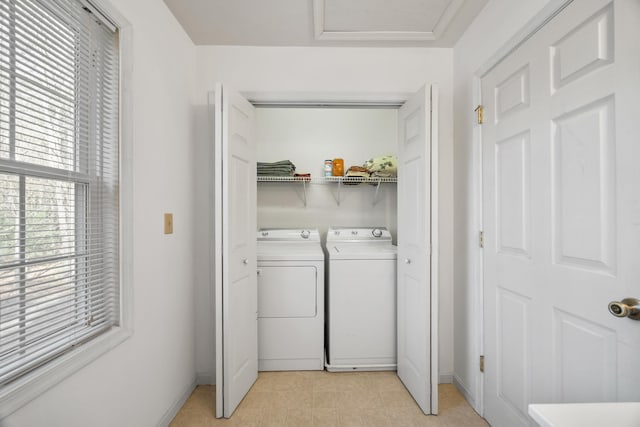 laundry area featuring washing machine and clothes dryer, laundry area, attic access, and baseboards