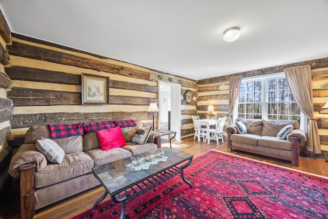 living room featuring wood walls and wood finished floors