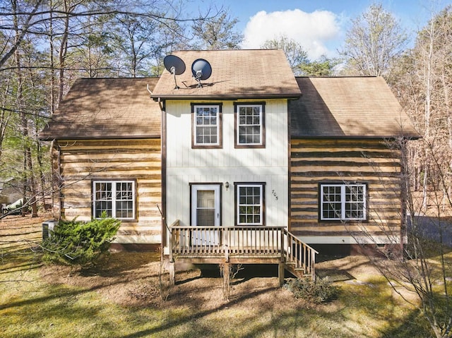rear view of house with a deck and a shingled roof
