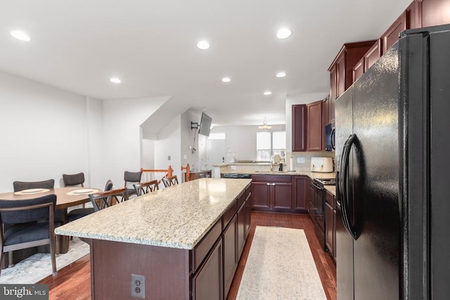 4556 Alliance Way, Fredericksburg, VA 22408 - kitchen featuring black appliances, a center island, dark wood-style flooring, recessed lighting, and light stone counters