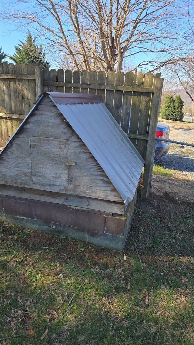 view of storm shelter with fence
