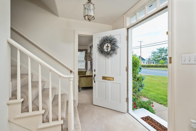 entryway with light colored carpet and stairway