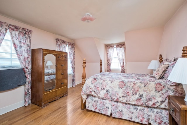 bedroom featuring wood finished floors and baseboards