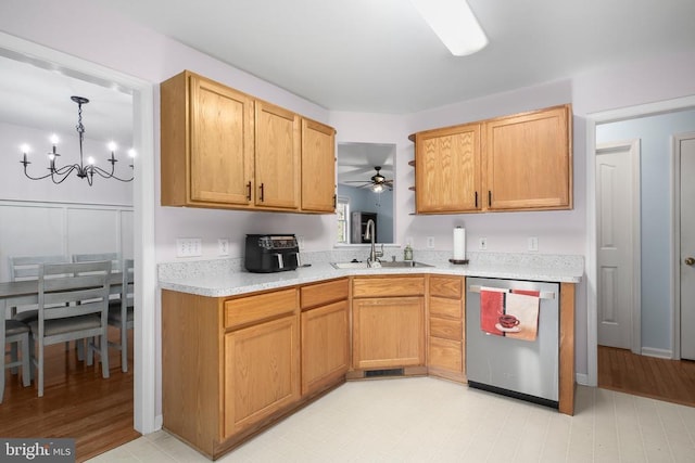 kitchen with light countertops, a sink, ceiling fan with notable chandelier, and dishwasher