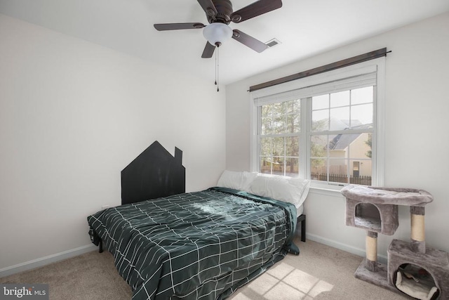 carpeted bedroom featuring baseboards, ceiling fan, and visible vents