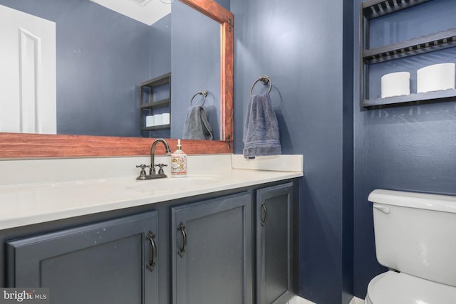 bathroom with toilet and vanity
