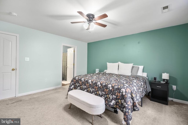 bedroom featuring ceiling fan, visible vents, carpet floors, baseboards, and ensuite bathroom