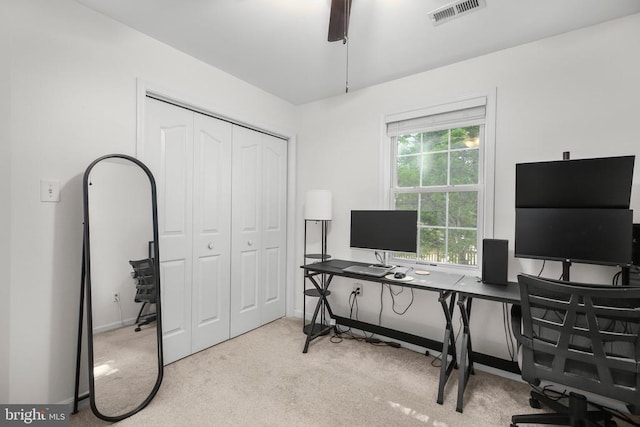 carpeted office space featuring visible vents and baseboards
