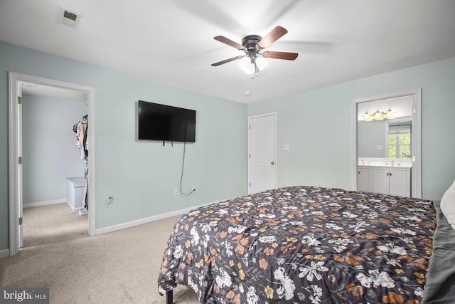bedroom featuring visible vents, a sink, baseboards, connected bathroom, and carpet