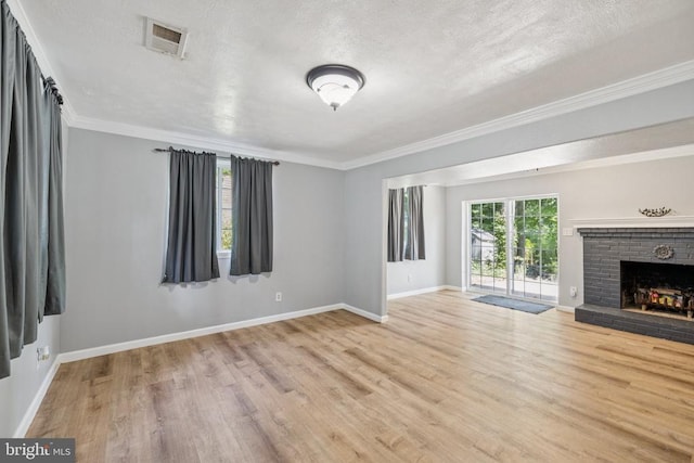 10603 Bluebird Ln, Spotsylvania, VA 22553 - unfurnished living room featuring wood finished floors, a textured ceiling, crown molding, and a brick fireplace