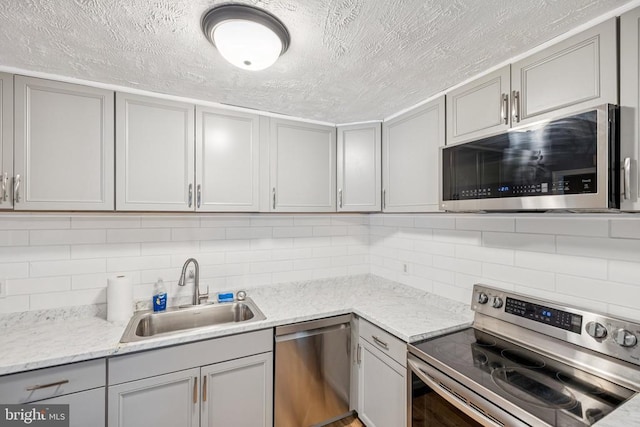 10603 Bluebird Ln, Spotsylvania, VA 22553 - kitchen with stainless steel appliances, gray cabinets, backsplash, and a textured ceiling