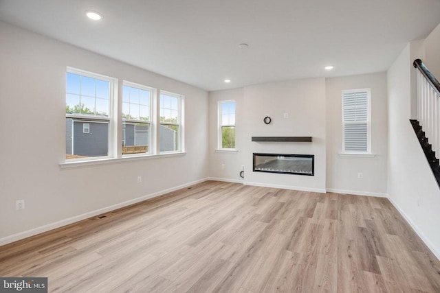 35663 Aspen Way, Locust Grove, VA 22508 - unfurnished living room with wood finished floors, baseboards, a glass covered fireplace, and recessed lighting