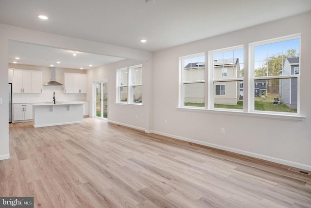 35663 Aspen Way, Locust Grove, VA 22508 - unfurnished living room with baseboards, light wood-style flooring, a sink, and recessed lighting