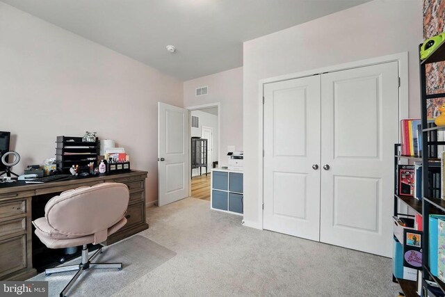 office space featuring light carpet and baseboards