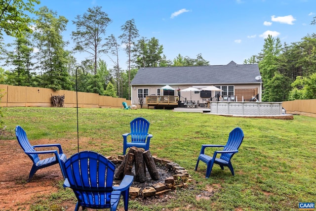 8289 Three Notch Rd, Louisa, VA 23093 - back of property with a wooden deck, an outdoor fire pit, a fenced backyard, and a pool