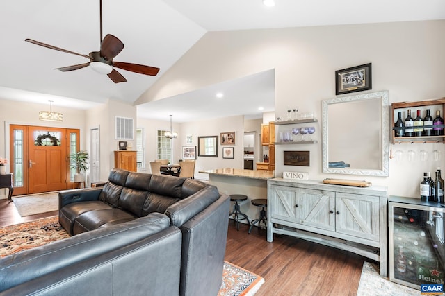 8289 Three Notch Rd, Louisa, VA 23093 - living area with beverage cooler, dark wood finished floors, a ceiling fan, high vaulted ceiling, and a chandelier