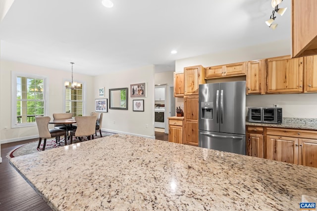 8289 Three Notch Rd, Louisa, VA 23093 - kitchen with stainless steel fridge with ice dispenser, a chandelier, light stone counters, dark wood finished floors, and pendant lighting