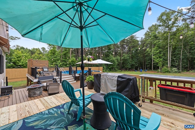 8289 Three Notch Rd, Louisa, VA 23093 - deck featuring an outdoor fire pit, grilling area, and a wooded view