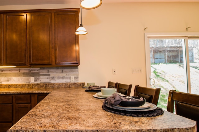 9839 Brunk Spring Ln, Broadway, VA 22815 - kitchen with a peninsula, light countertops, hanging light fixtures, and backsplash