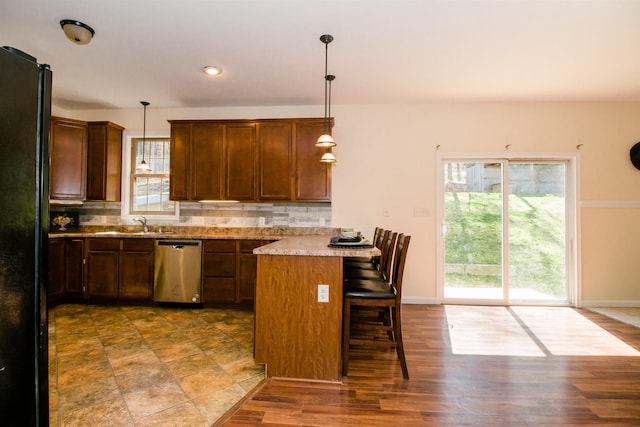 9839 Brunk Spring Ln, Broadway, VA 22815 - kitchen with dishwasher, freestanding refrigerator, a kitchen bar, light countertops, and backsplash